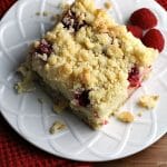 Raspberry Cream Cheese Crumb Cake is layered with a creamy cheesecake , fresh raspberries, and topped with a cruchy streusel topping. Perfect for brunch or dessert! | Persnickety Plates