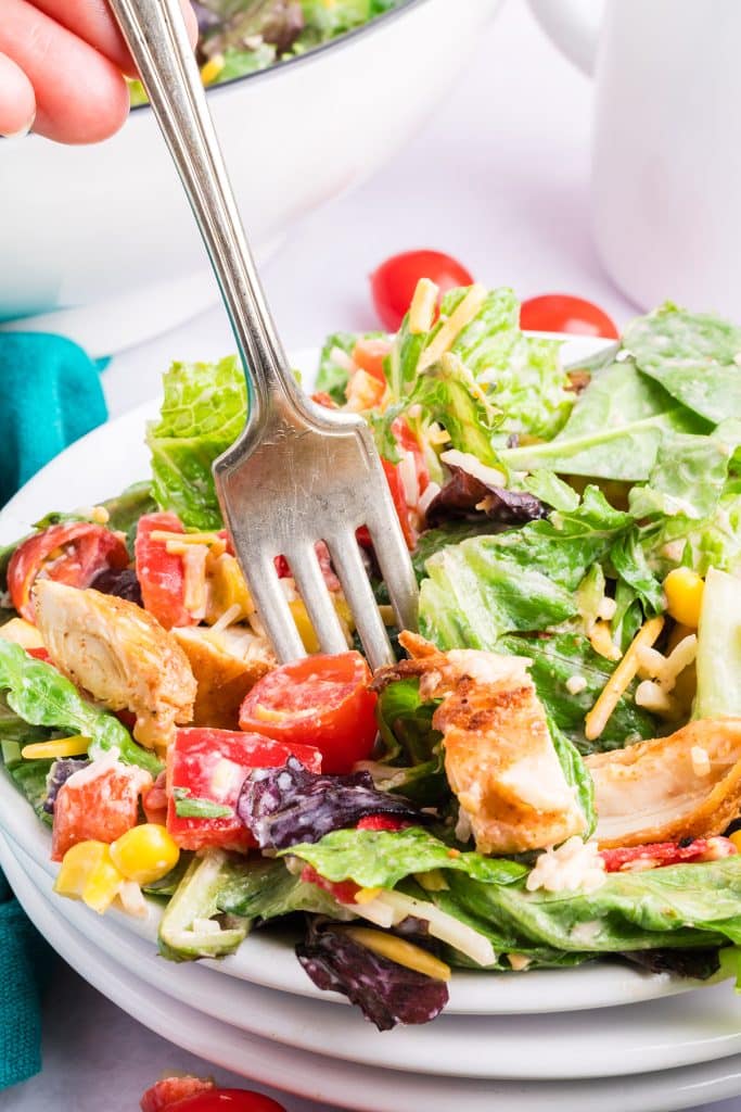 fork taking a bite of salad.