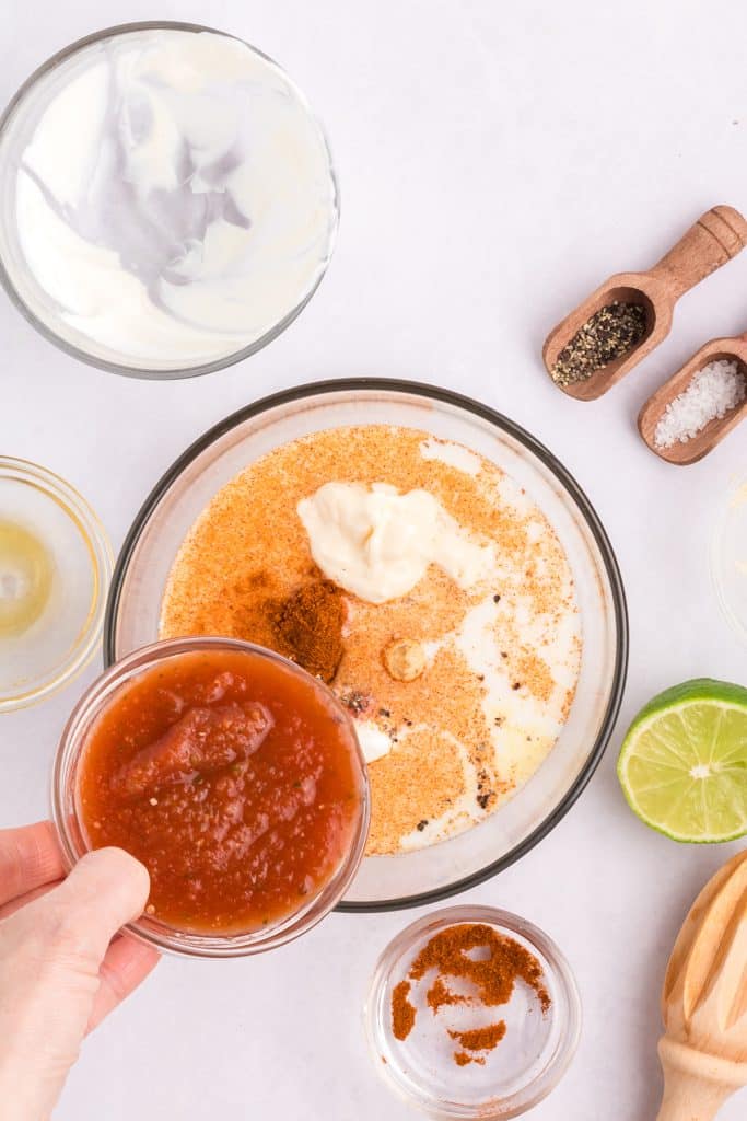 salsa pouring into a bowl.