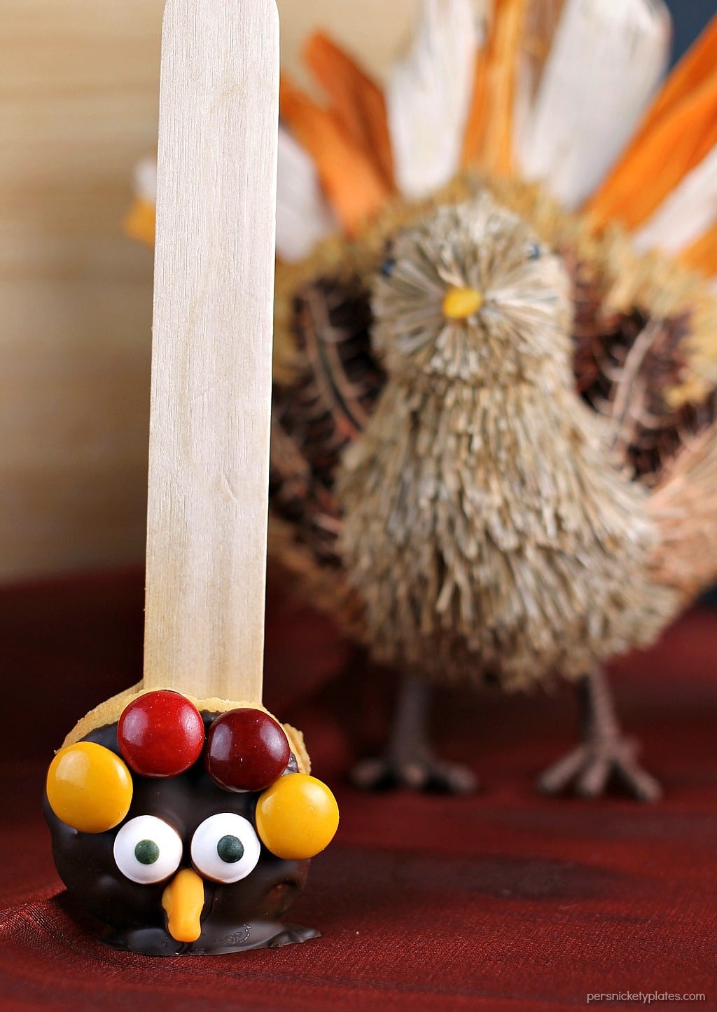 Nilla Wafer Thanksgiving Turkeys are cookies sandwiched together with peanut butter, dipped in chocolate, and decorated with fall colored M&Ms, candy corn, and candy eyes, all on a popsicle stick! So fun for the kids and festive for the Thanksgiving table!