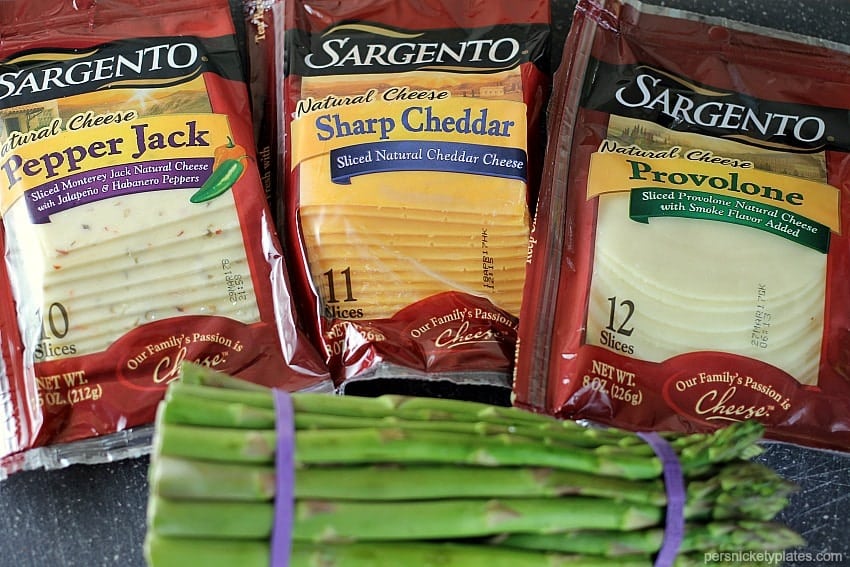 sargento sliced cheese packages and a bundle of fresh asparagus