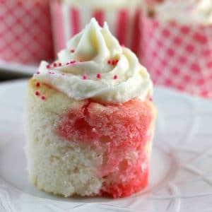 Strawberry Jello Poke Cupcakes start with a white cake mix but are jazzed up when you poke holes in them and pour on some strawberry Jello. It makes for a really moist, flavorful, and pretty cupcake! | Persnickety Plates