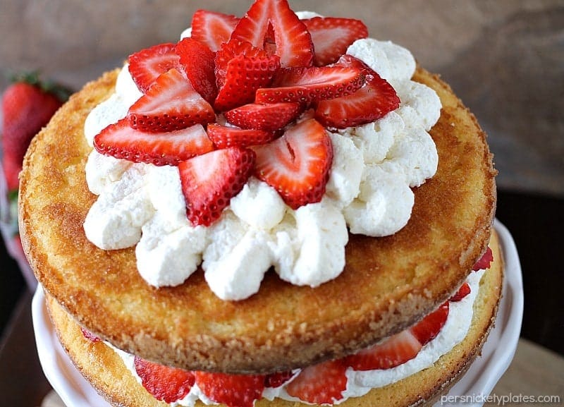 Strawberry Shortcake Cake is a rustic vanilla layer cake filled with a whipped cream cheese frosting and fresh strawberries. Easy, impressive, and SO good! | www.persnicketyplates.com