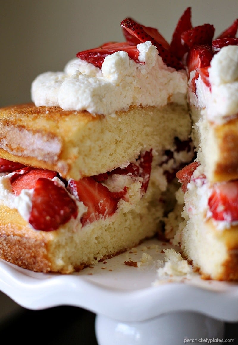 Strawberry Shortcake Cake is a rustic vanilla layer cake filled with a whipped cream cheese frosting and fresh strawberries. Easy, impressive, and SO good! | www.persnicketyplates.com