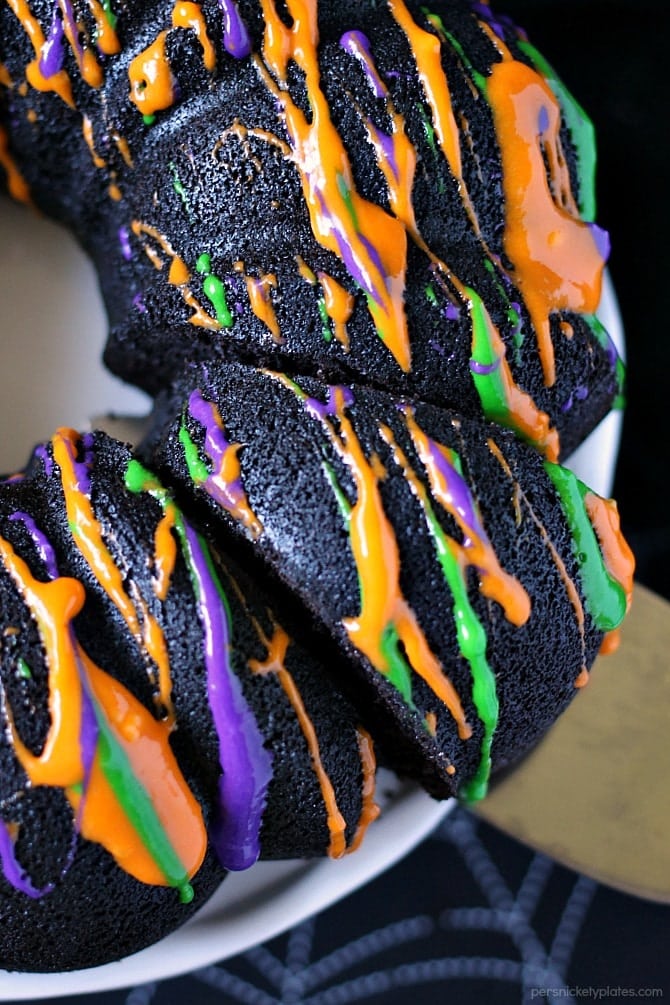 Halloween Chocolate Tunnel Cake is a moist, from scratch, dark chocolate cake filled with a tunnel of orange cheesecake center and drizzled with a cream cheese frosting. Just the right amount of festive and spooky for your Halloween party! | www.persnicketyplates.com