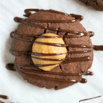 close up of chocolate cookie filled with peanut butter and drizzled with chocolate