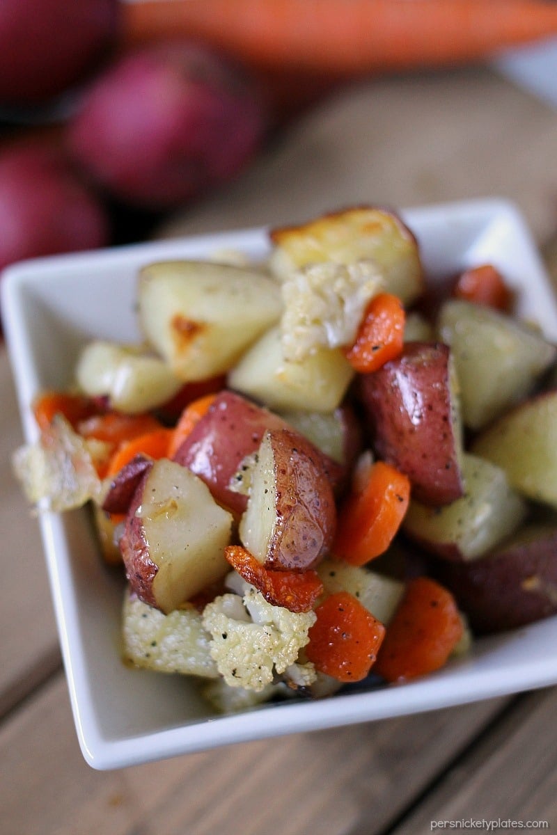 Garlic Roasted Veggies are a mix of cauliflower, carrots, and red skin potatoes tossed in olive oil and garlic and roasted to perfection. | www.persnicketyplates.com