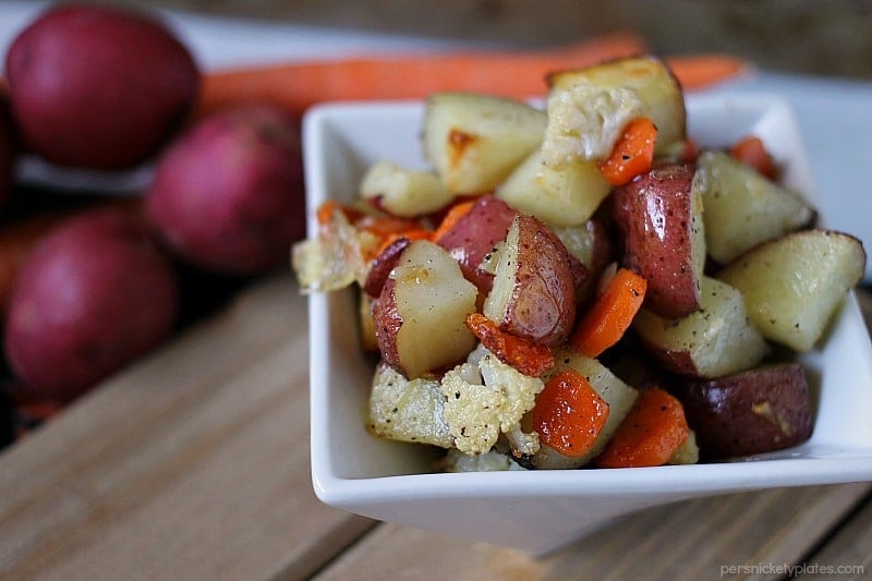 Garlic Roasted Veggies are a mix of cauliflower, carrots, and red skin potatoes tossed in olive oil and garlic and roasted to perfection. | www.persnicketyplates.com