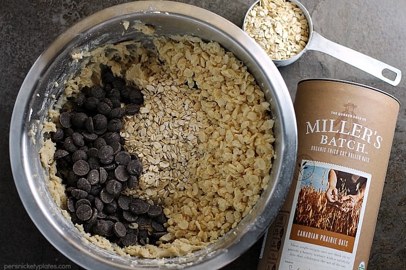 overhead shot of mixing bowl with chocolate chips, oats, and crispy rice cereal for cookies.