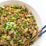 chicken fried rice with vegetables top view with chopsticks