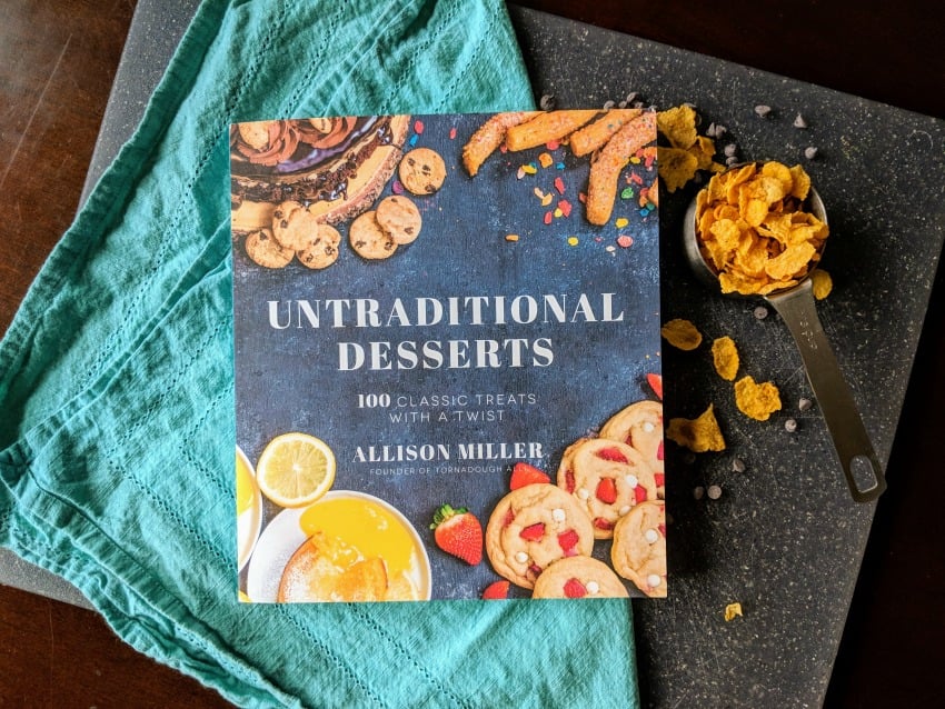 untraditional desserts cookbook on cutting board Chocolate Peanut Butter Cornflake Cookies are a sweet and salty no-bake cookie that you can whip up in no time! | www.persnicketyplates.com