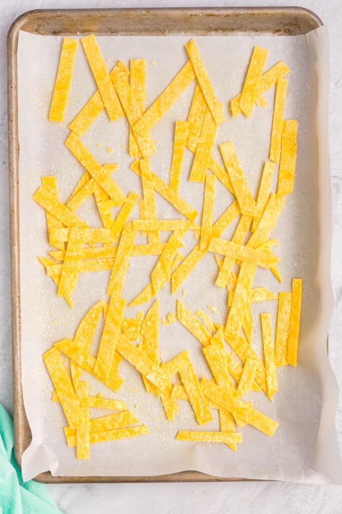 sliced tortilla strips on a baking sheet.