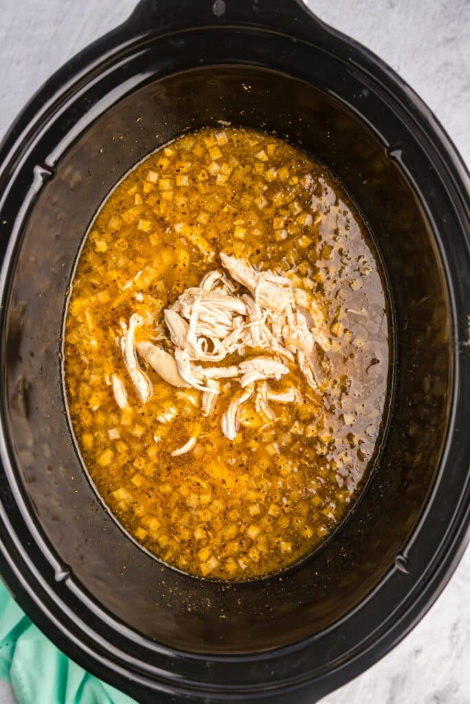 shredded chicken in a crockpot of soup.