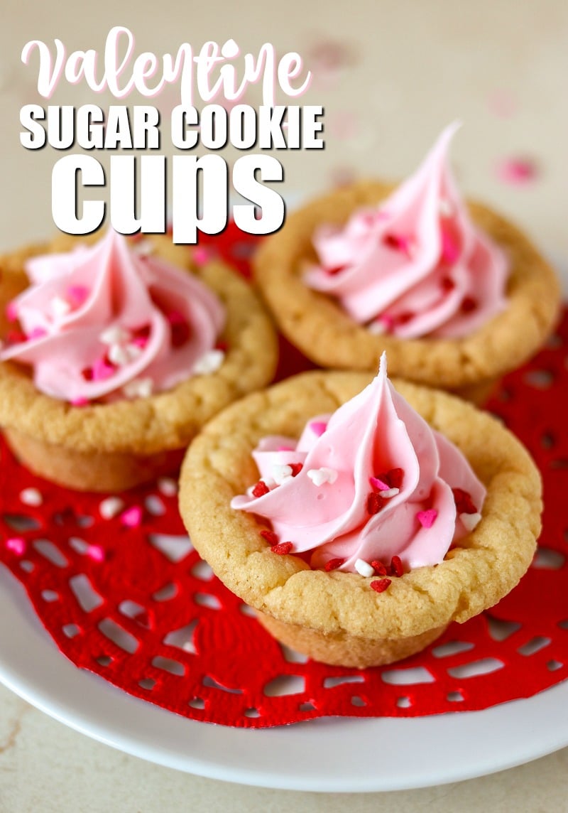 Valentine Sugar Cookie Cups are a simple, semi-homemade treat that you can whip up in no time! A sugar cookie base filled with pink frosting and topped with Valentine sprinkles. | www.persnicketyplates.com