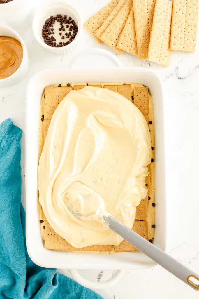 pudding spreading over graham crackers in a dish.