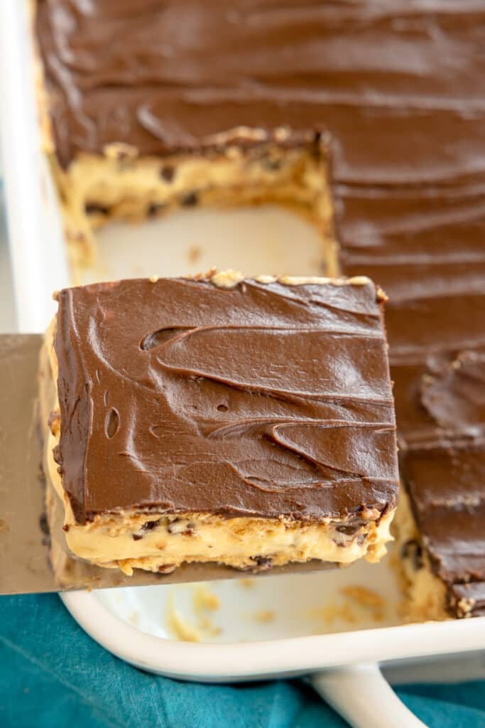 slice of chocolate eclair cake lifting from the pan.