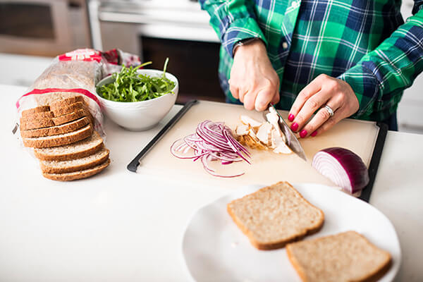 chicken being chopped on a cutting board