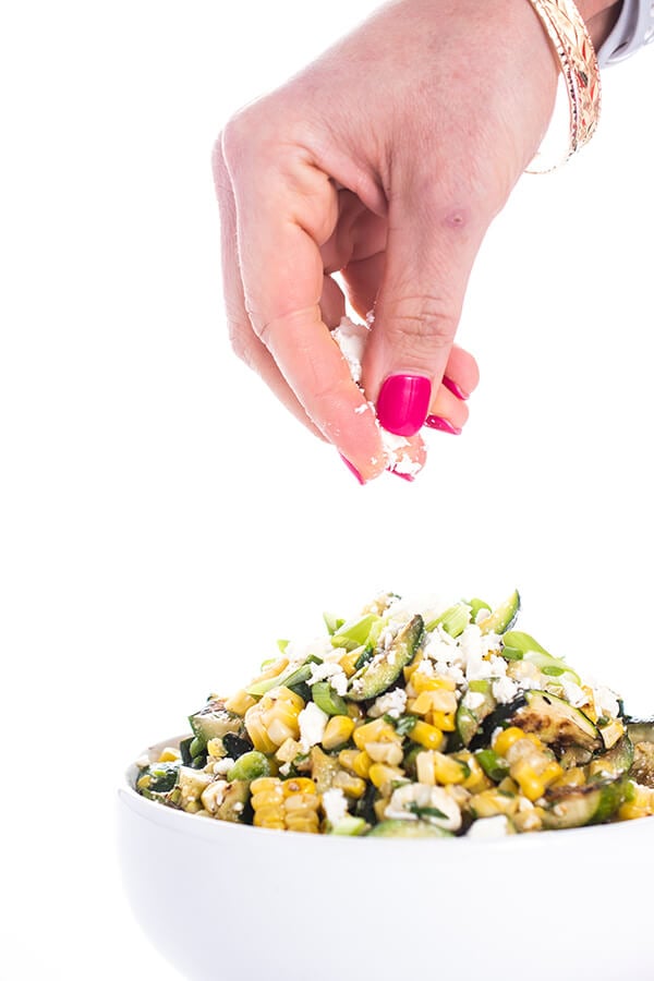 zucchini salad with feta being sprinkled in