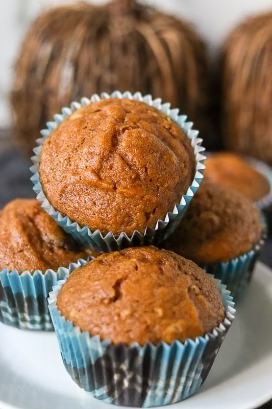 stack of pumpkin muffins with blue plaid wrappers