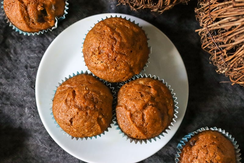 three pumpkin muffins on white plate