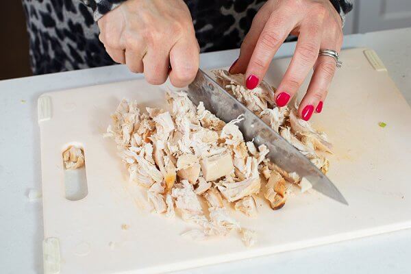 Liz cutting up turkey breast into small pieces.