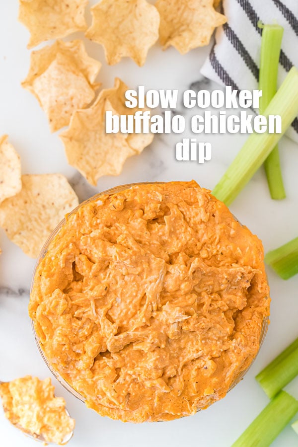 overhead shot of bowl of buffalo chicken dip with chips & celery
