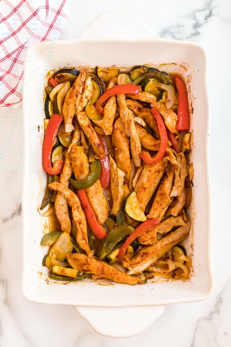 baked chicken fajitas in a white baking dish