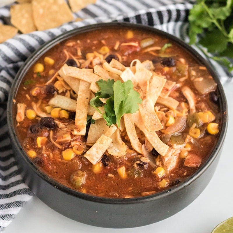 black bowl full of chicken tortilla soup