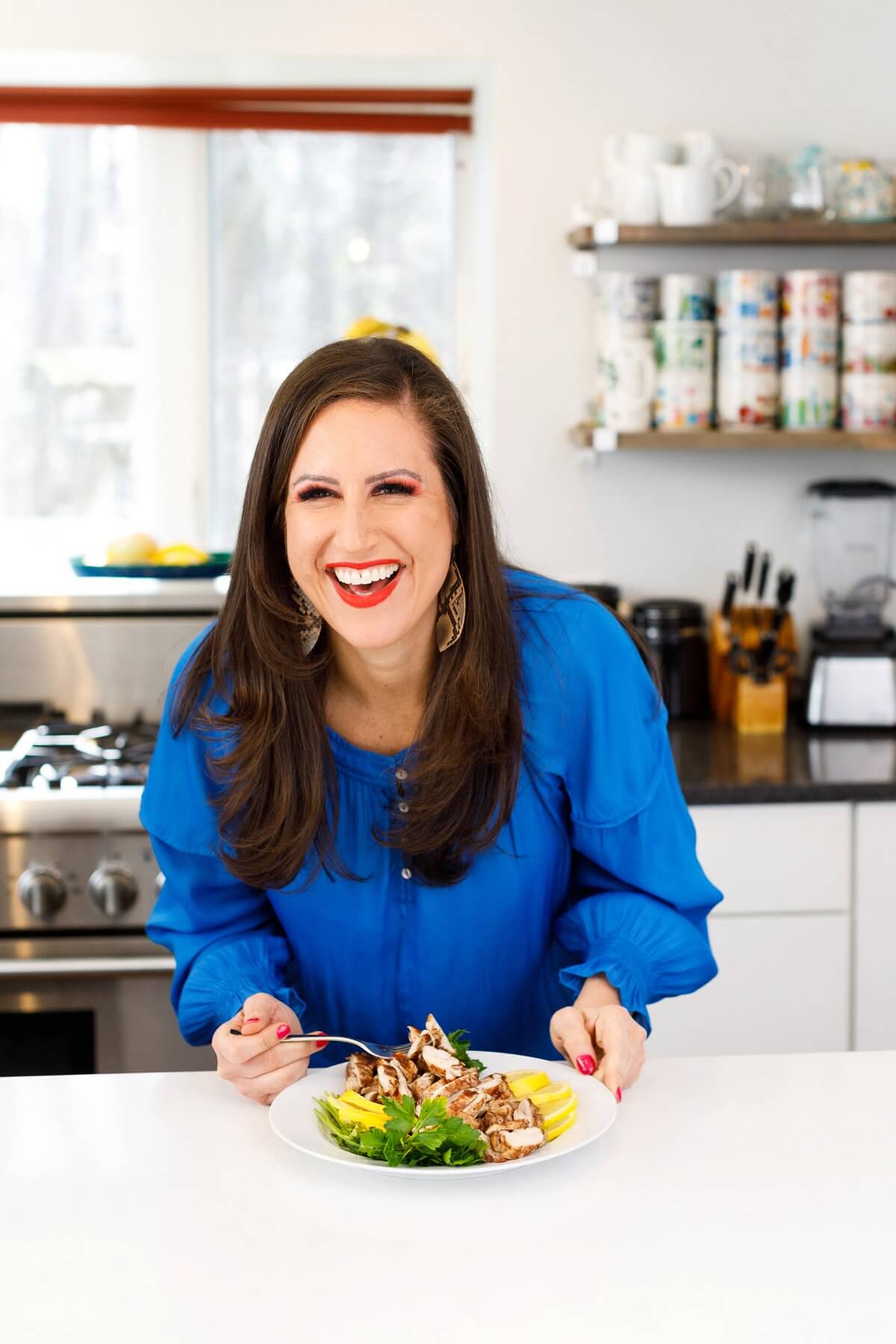 Liz eating sheet pan lebanese chicken shawarma.
