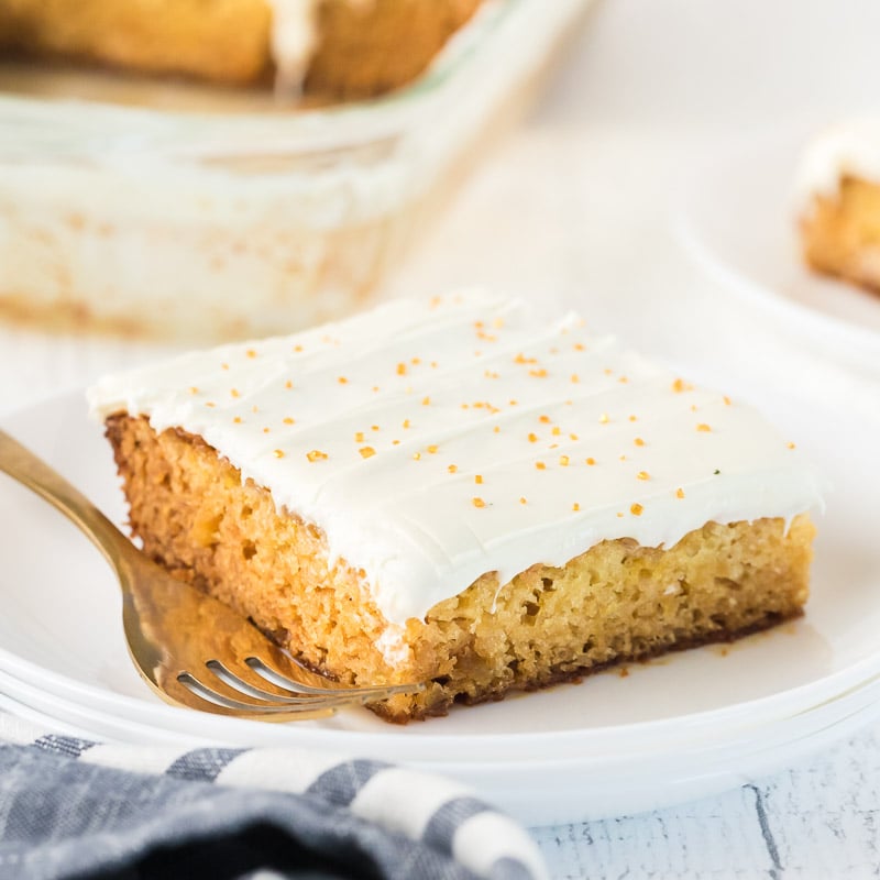 slice of mexican wedding cake on a white plate with a fork