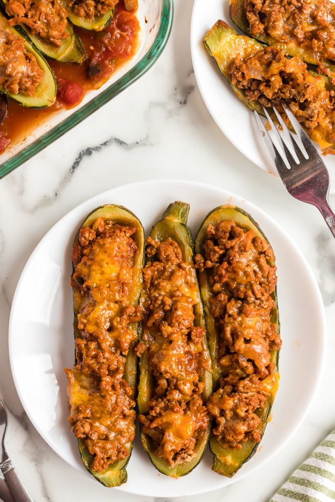 overhead shot of zucchini boats on white plate