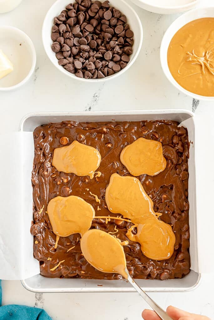 peanut butter dollops on top of brownie batter.