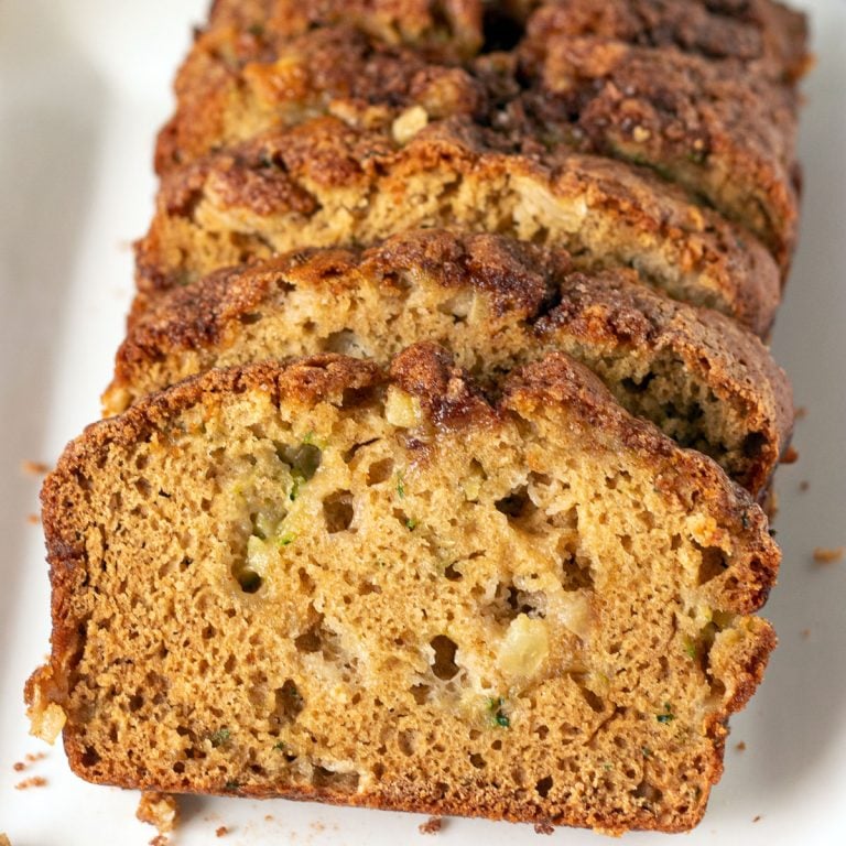 sliced apple zucchini quick bread on white plate