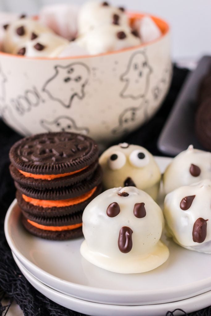 stack of halloween oreos next to oreo balls