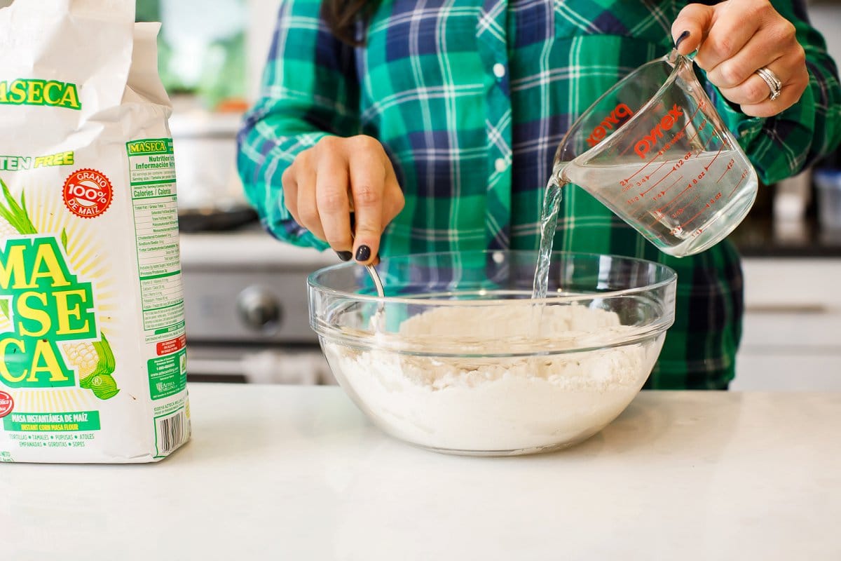 mixing flour and water for corn tortillas 