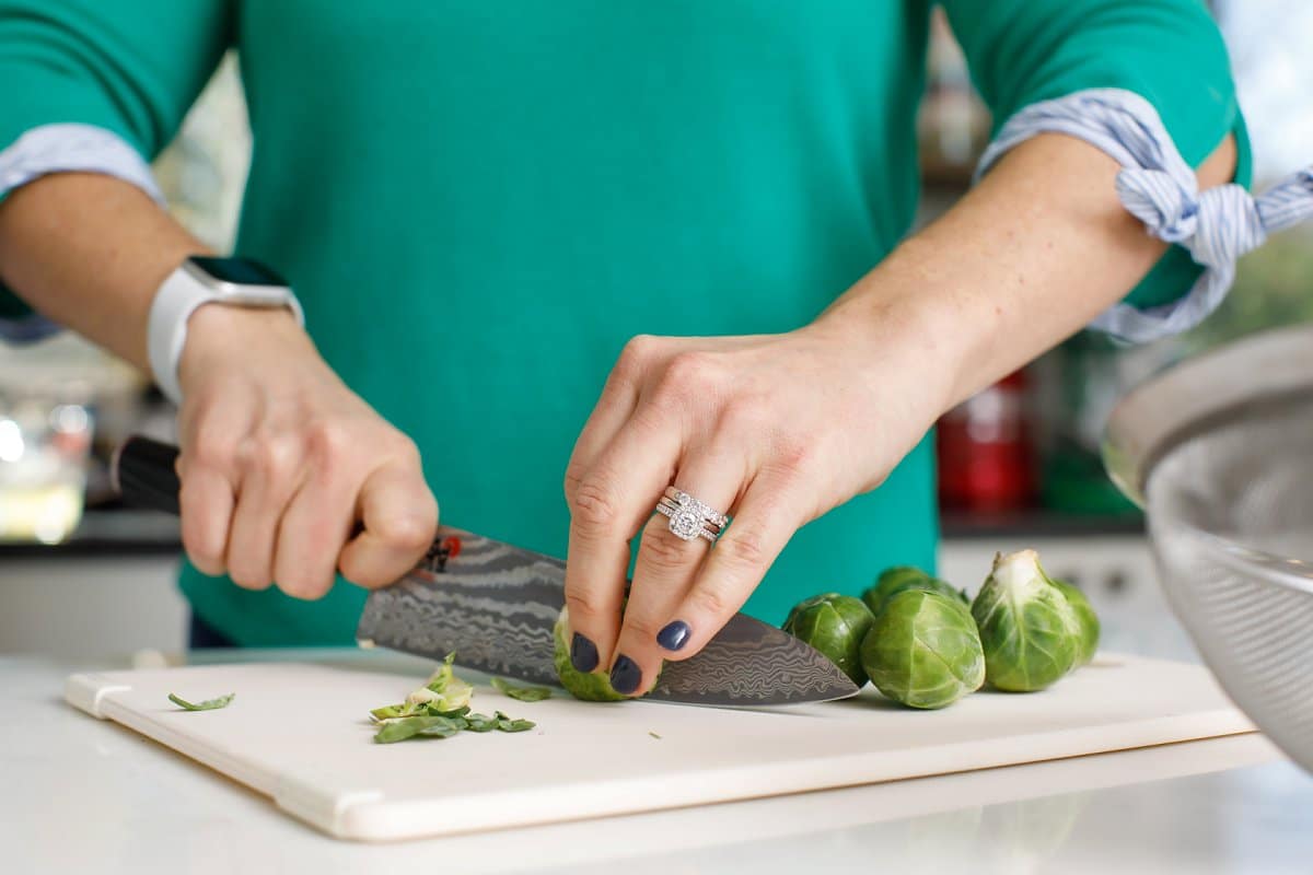 woman slicing Brussels sprouts 