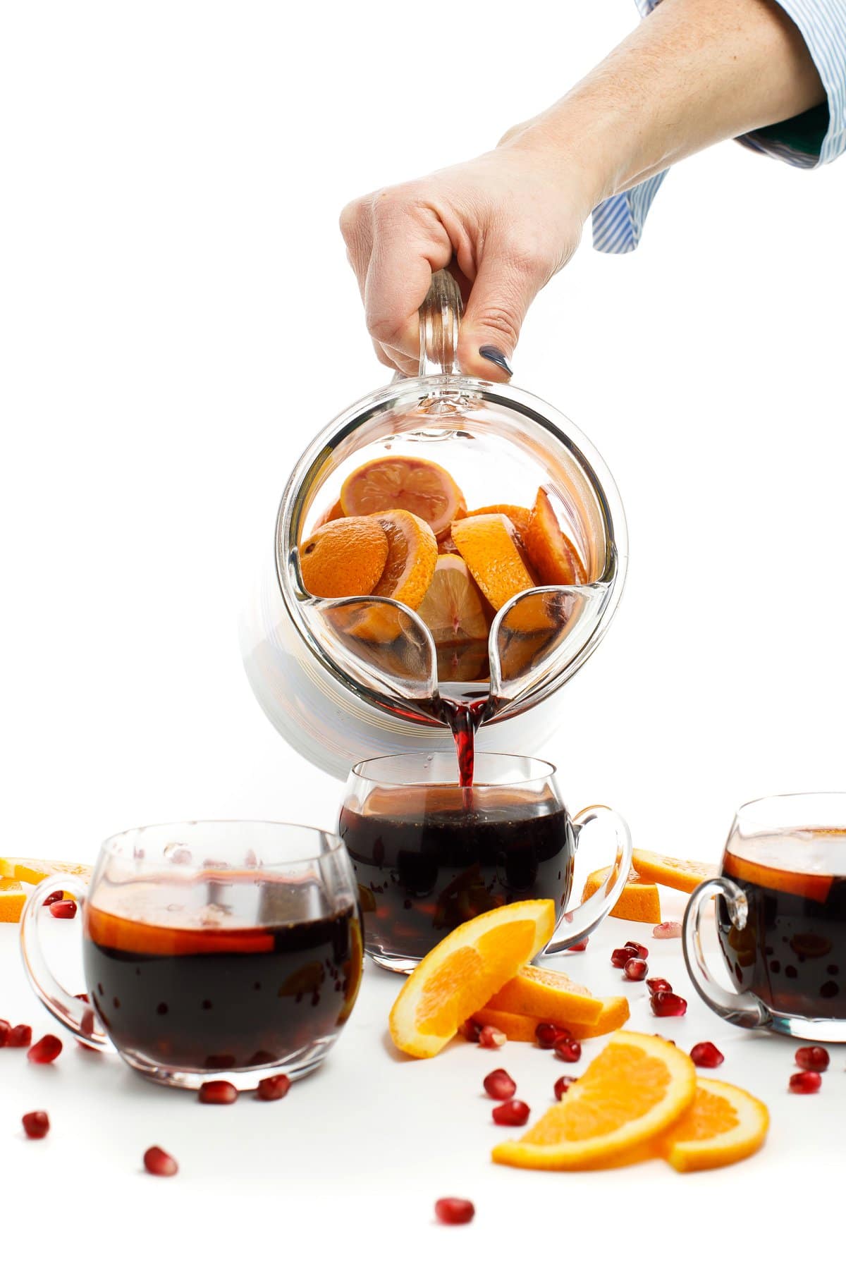 Pomegranate sangria poured from pitcher