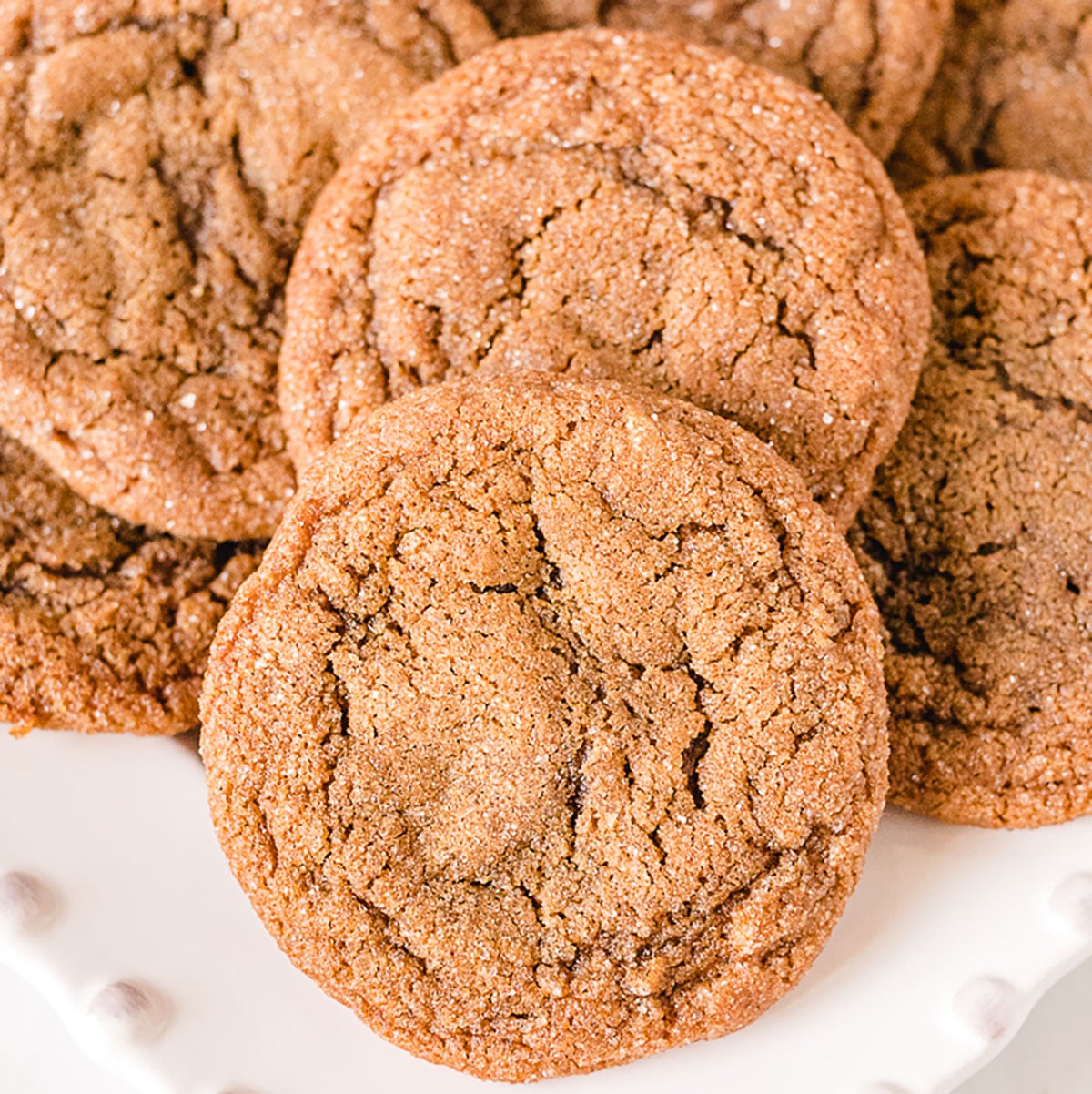 pile of molasses cookies on white platter