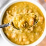 spoon of split pea soup over a bowl