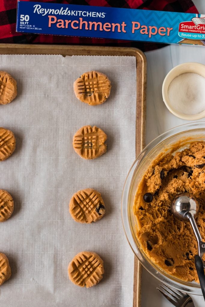 overhead shot of peanut butter cookies on a baking sheet
