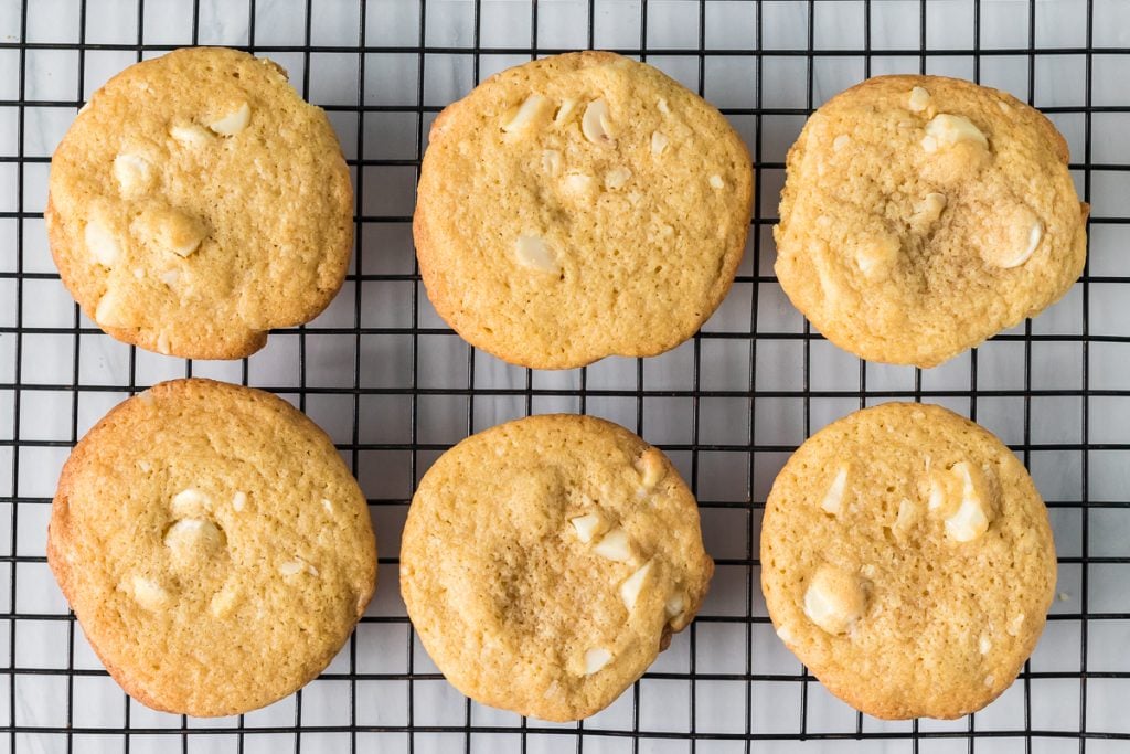 white chocolate macadamia nut cookies on a wire cooling rack