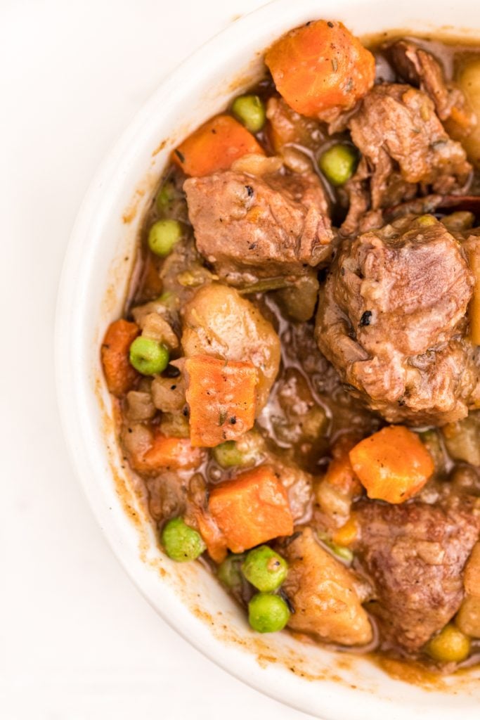 slow up of beef stew in a white bowl