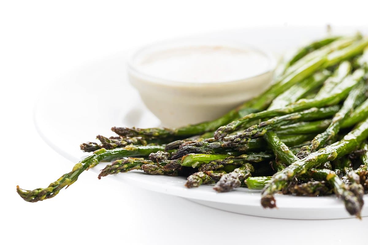 plate of broiled asparagus with tahini