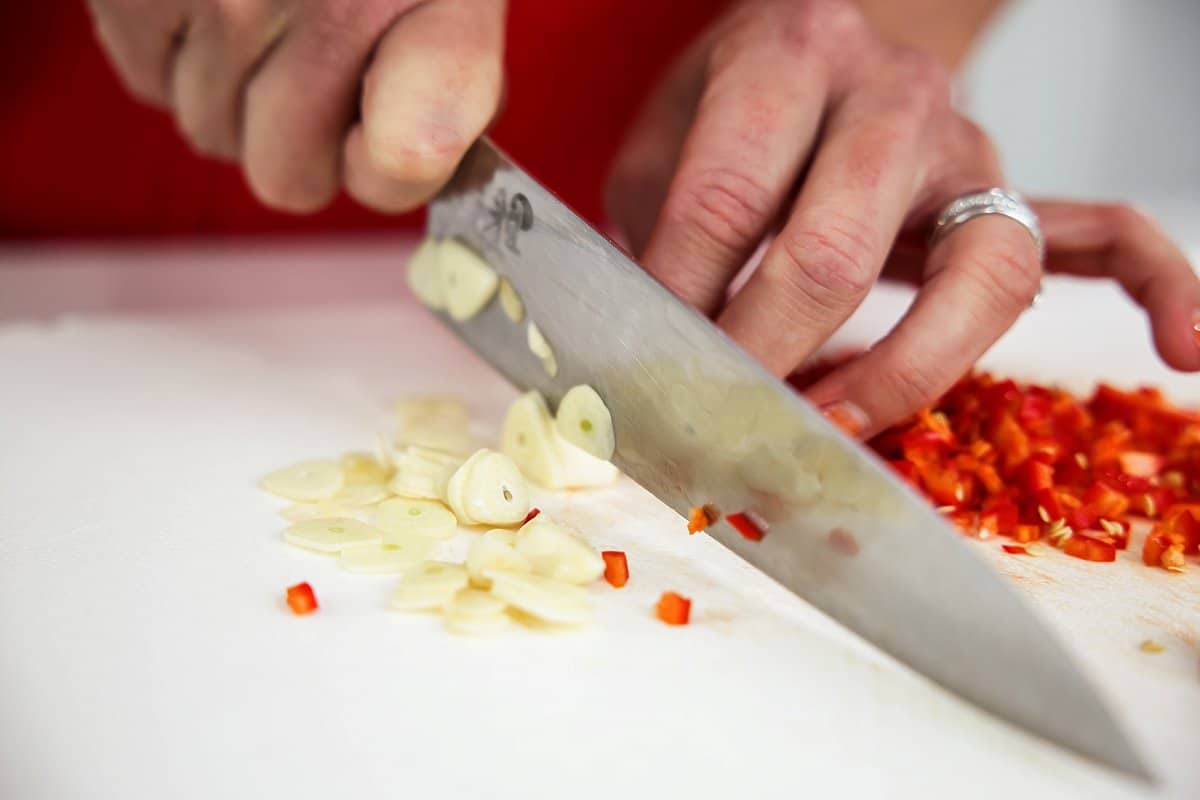 slicing garlic and red chilis
