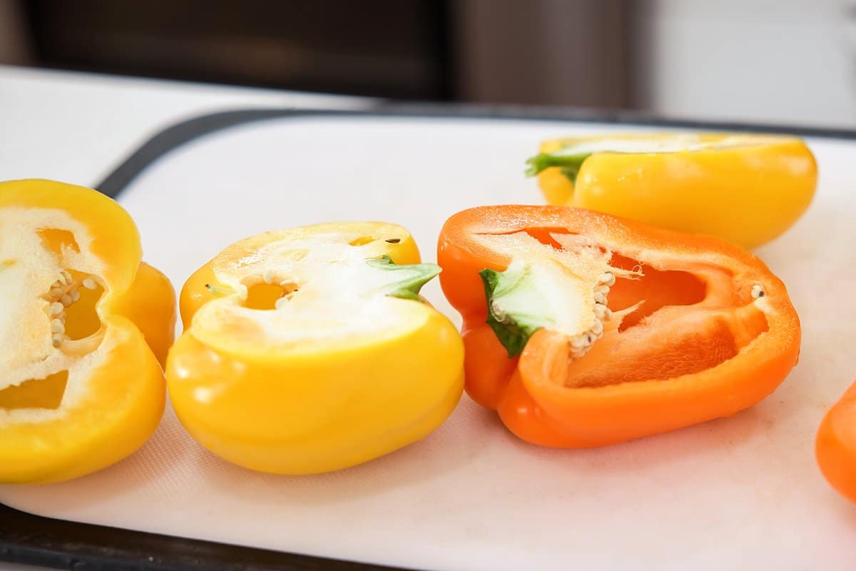 preparing peppers on a cutting board