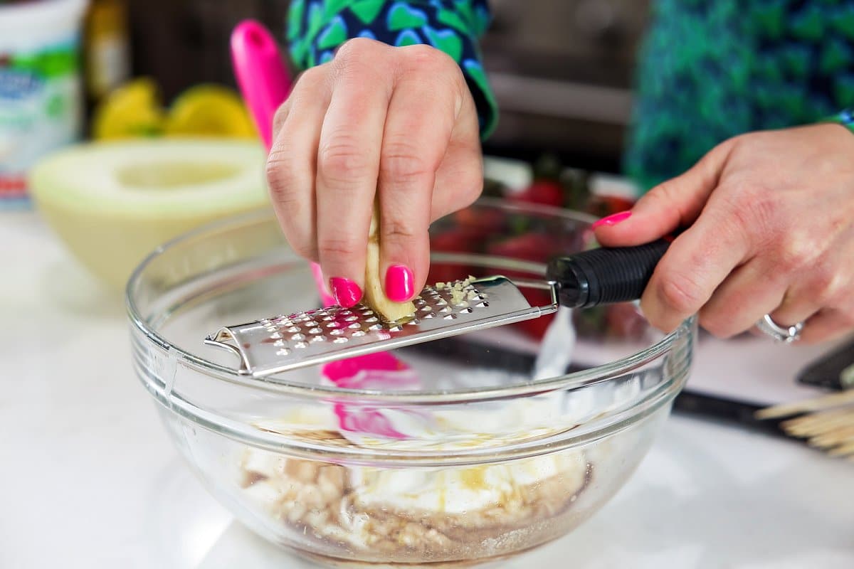 grading ginger into a bowl