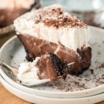 slice of chocolate pudding pie with a bite on a fork next to it