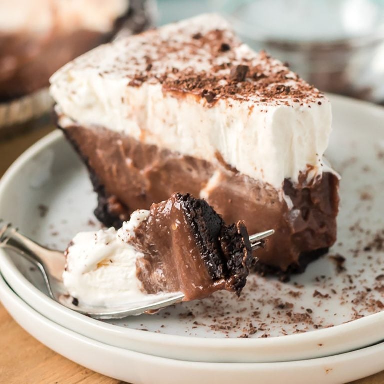 slice of chocolate pudding pie with a bite on a fork next to it