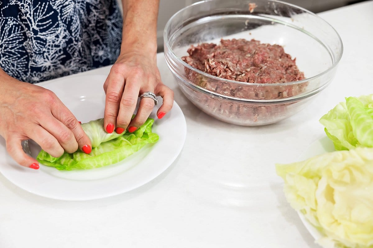 cabbage leaves and raw meat in a bowl