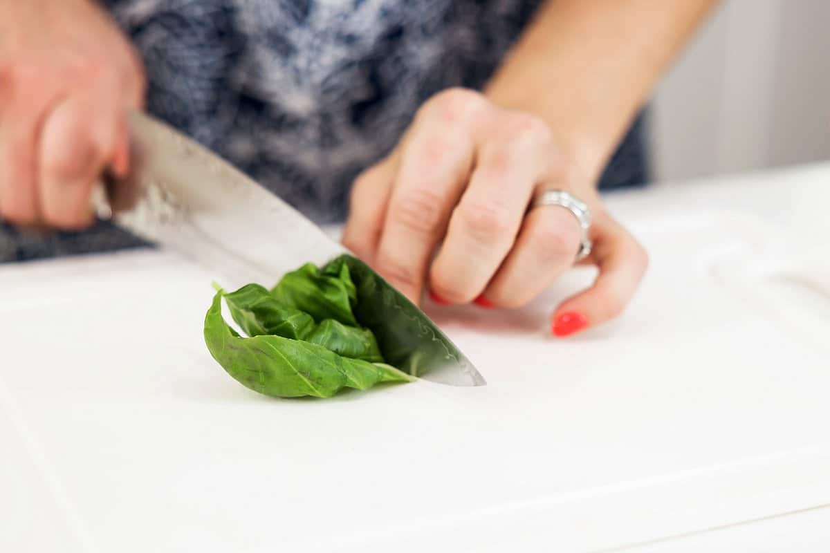 basil being cut